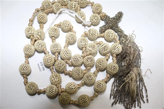 A reticulated ivory bead and tassel drop rosary necklace, 100cm.